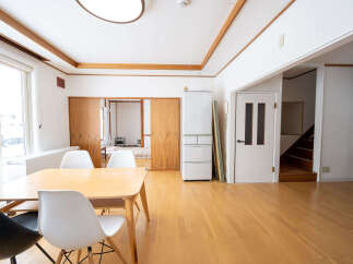 Bright and airy living space with hardwood floors and large windows.