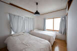 Cozy bedroom with two twin beds, perfect for a relaxing stay.