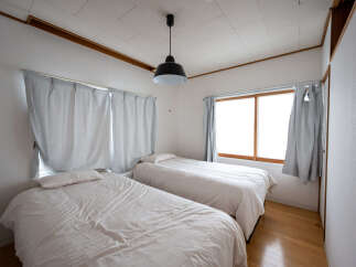 Cozy bedroom with two twin beds, perfect for a relaxing stay.