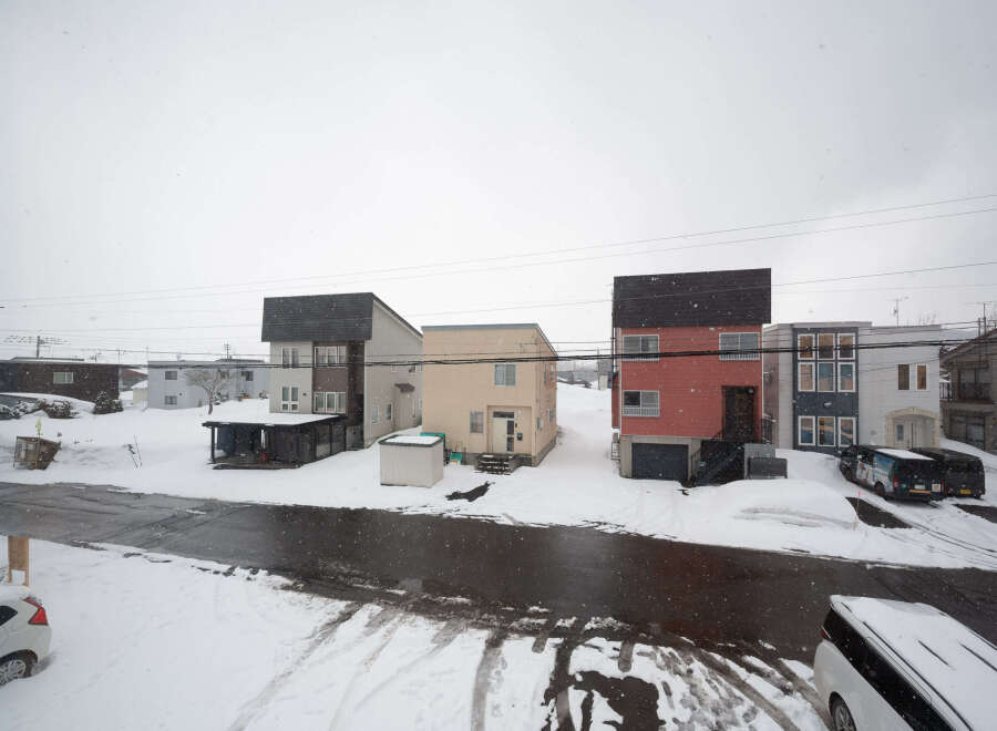 Charming snow-covered houses with unique architectural designs.
