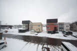 Charming snow-covered houses with unique architectural designs.
