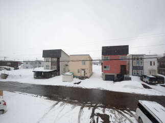 Charming snow-covered houses with unique architectural designs.