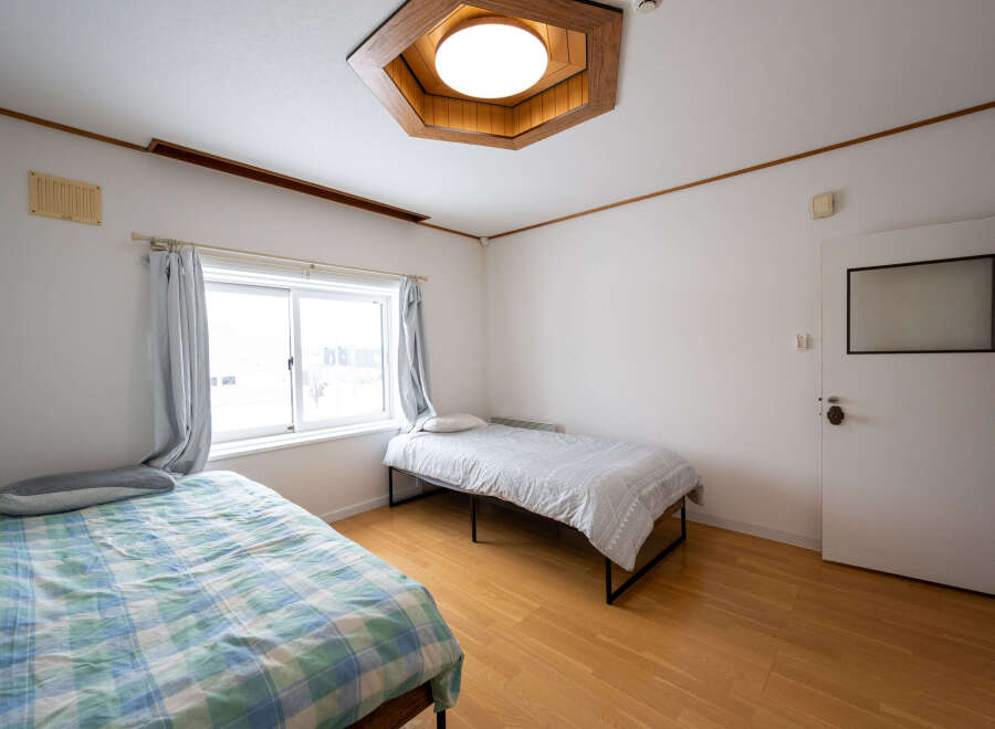 Cozy bedroom with two single beds, perfect for roommates or guests.
