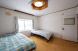 Cozy bedroom with two single beds, perfect for roommates or guests.