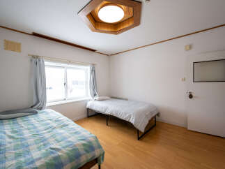 Cozy bedroom with two single beds, perfect for roommates or guests.