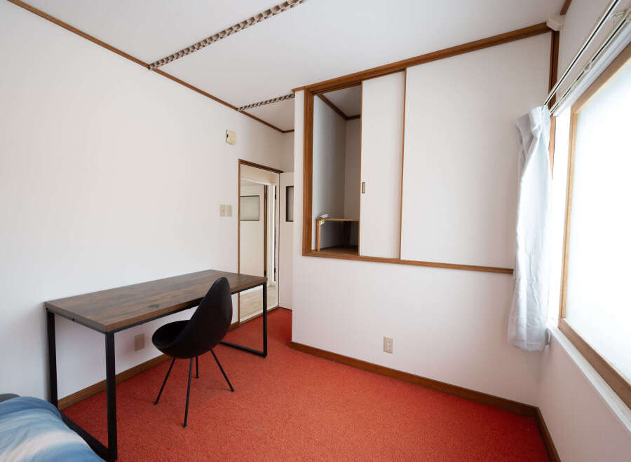 Cozy bedroom with a built-in closet and a desk perfect for working from home.