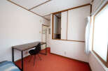 Cozy bedroom with a built-in closet and a desk perfect for working from home.