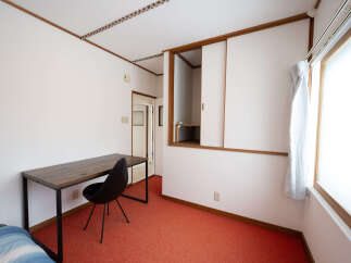 Cozy bedroom with a built-in closet and a desk perfect for working from home.