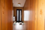 Step inside this charming home featuring a welcoming entryway with wood paneling and a tiled floor.