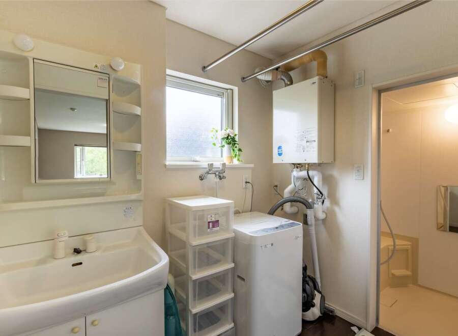 This charming property boasts a well-equipped laundry area complete with a washing machine and ample storage.