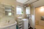This charming property boasts a well-equipped laundry area complete with a washing machine and ample storage.