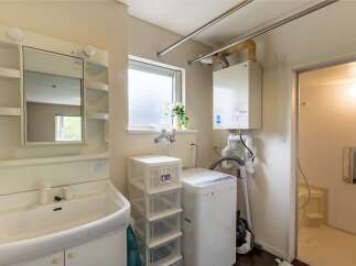 This charming property boasts a well-equipped laundry area complete with a washing machine and ample storage.