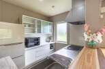Modern kitchen with sleek white cabinets and stainless steel appliances.