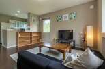 Cozy living room with a comfortable couch, coffee table, and flat-screen TV.