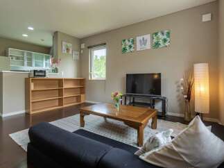 Cozy living room with a comfortable couch, coffee table, and flat-screen TV.
