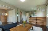 Cozy apartment featuring a modern kitchen, built-in shelving, and a relaxing living area.