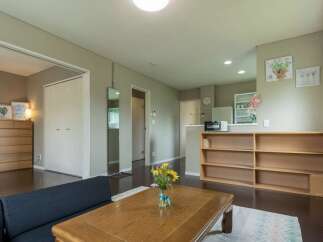 Cozy apartment featuring a modern kitchen, built-in shelving, and a relaxing living area.