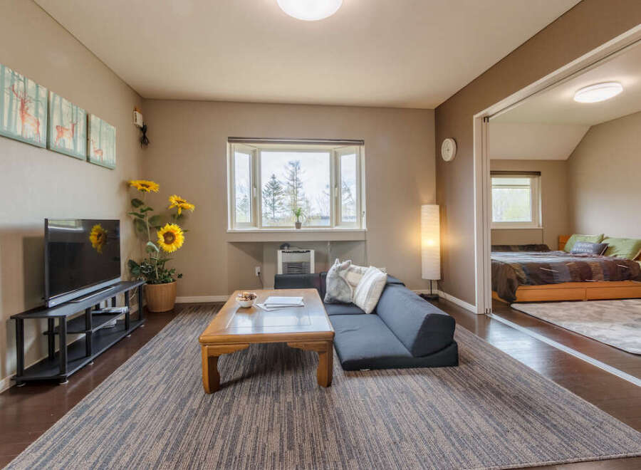 Cozy living room with comfortable seating and a large TV, perfect for relaxing after a day of exploring.