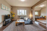 Cozy living room with comfortable seating and a large TV, perfect for relaxing after a day of exploring.