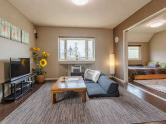 Cozy living room with comfortable seating and a large TV, perfect for relaxing after a day of exploring.