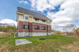 This stunning house boasts a spacious layout, large windows offering abundant natural light, and a modern design.