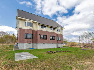 This stunning house boasts a spacious layout, large windows offering abundant natural light, and a modern design.