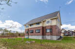 This stunning house boasts a spacious design with large windows, offering abundant natural light.