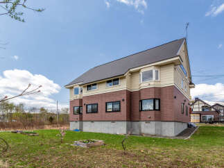 This stunning house boasts a spacious design with large windows, offering abundant natural light.
