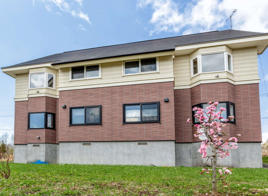 This stunning house boasts a modern design with a combination of brick and siding, creating a beautiful aesthetic.