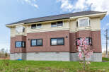 This stunning house boasts a modern design with a combination of brick and siding, creating a beautiful aesthetic.