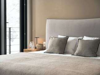 Wake up to breathtaking views from this cozy bedroom, featuring a plush bed and soft linens.