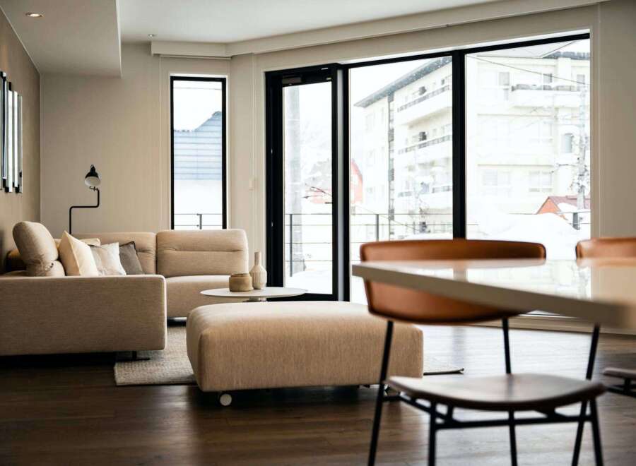 Modern living space with floor-to-ceiling windows offering stunning city views.