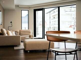 Modern living space with floor-to-ceiling windows offering stunning city views.