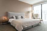 Luxurious bedroom with a king-size bed, plush carpet, and large windows offering stunning views.