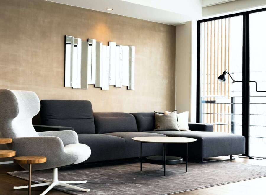 Modern living room with stylish dark gray sectional sofa and comfortable accent chair.