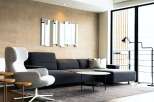 Modern living room with stylish dark gray sectional sofa and comfortable accent chair.