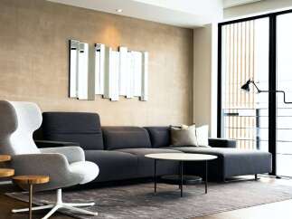 Modern living room with stylish dark gray sectional sofa and comfortable accent chair.