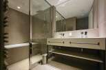Modern bathroom with a glass shower enclosure, double vanity, and freestanding bathtub.