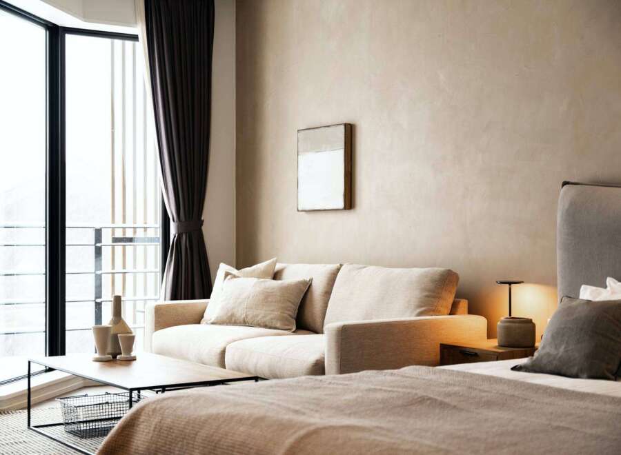 Relax in our stylish hotel room, featuring a comfortable sofa and large window with scenic views.