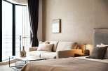 Relax in our stylish hotel room, featuring a comfortable sofa and large window with scenic views.