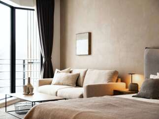 Relax in our stylish hotel room, featuring a comfortable sofa and large window with scenic views.