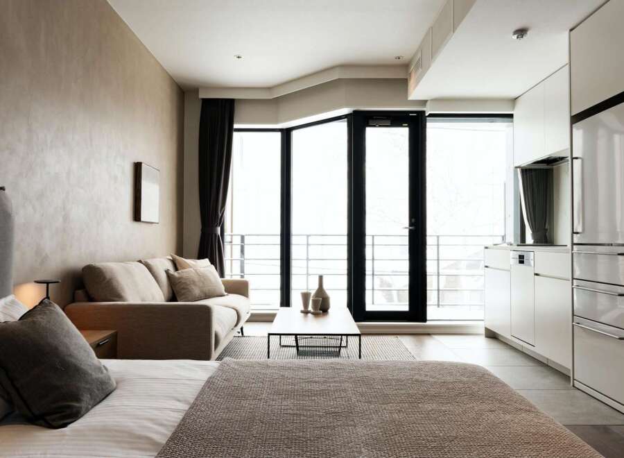 Modern studio apartment with open-plan living and kitchen area.