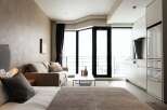 Modern studio apartment with open-plan living and kitchen area.