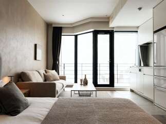 Modern studio apartment with open-plan living and kitchen area.