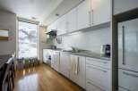 Modern kitchen with snowy mountain views.
