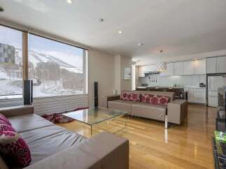 This stunning condo boasts breathtaking mountain views from its large windows, creating a serene and relaxing atmosphere.
