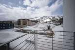 Luxury apartments with breathtaking views of snow-capped mountains and ski slopes.