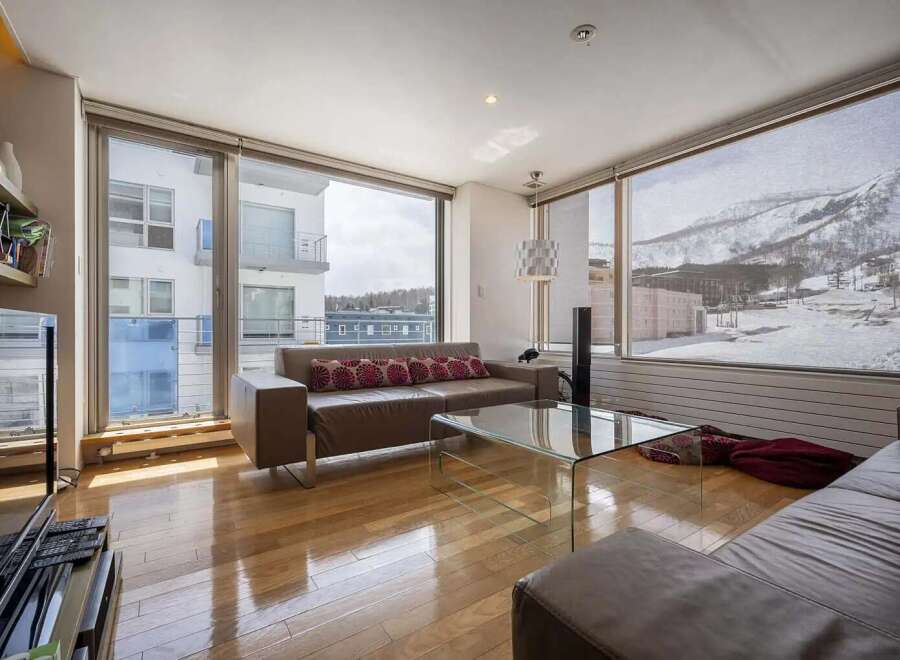 This stunning apartment boasts breathtaking views of snow-capped mountains and a modern, open-plan living area.