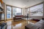 This stunning apartment boasts breathtaking views of snow-capped mountains and a modern, open-plan living area.
