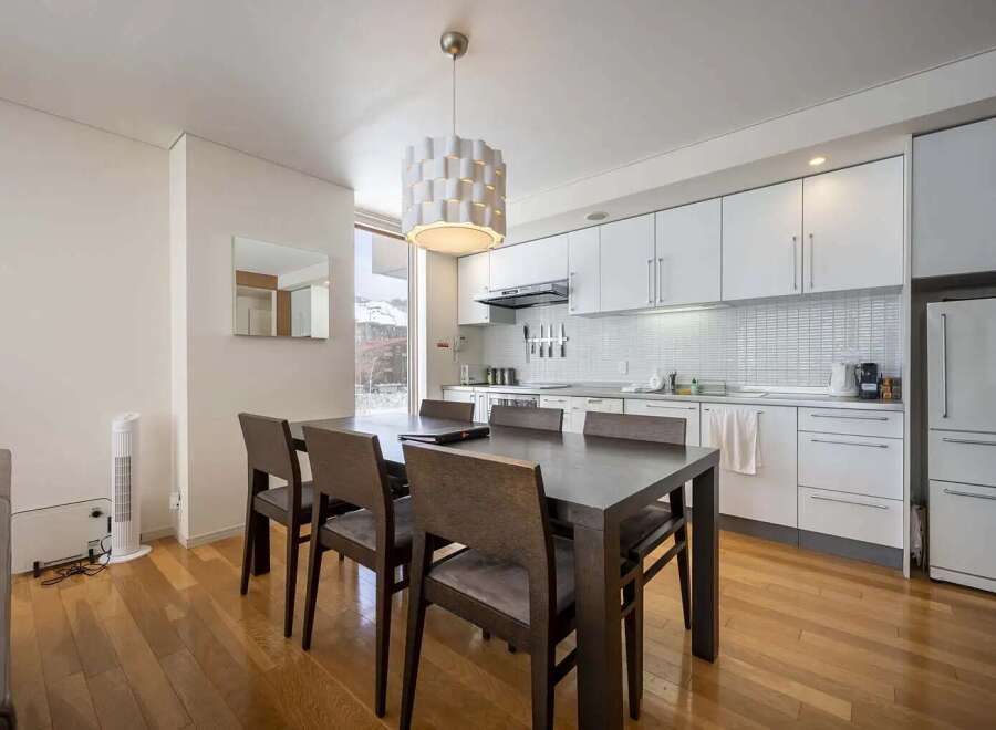 Modern condo with open concept kitchen and dining area, perfect for entertaining.